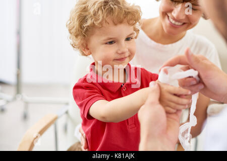 Putting Verband am verletzten Finger Stockfoto