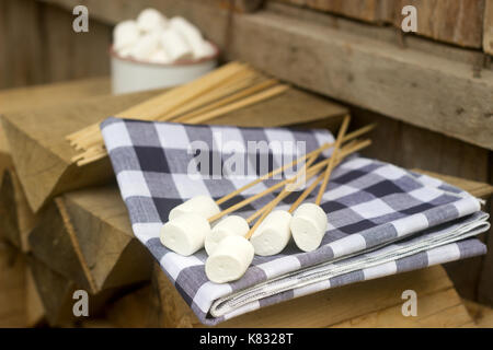 Marshmallow auf Holzstäbchen zum Braten auf einem offenen Feuer. Rustikaler Stil, selektiven Fokus. Stockfoto