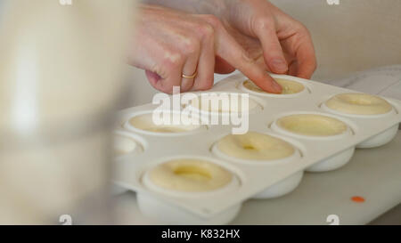 Hausgemachte Schokolade Muffins in Silikon Form in den Backofen. Kochen Muffins im Werkzeug, in der Nahaufnahme Stockfoto