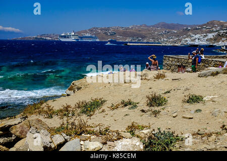 Allgemeine Blick auf die Waterfront, Gebäuden und Menschen angeln in Mykonos, Griechenland im Juli 2016. Auch Möwen warten auf einen Geschmack von Fisch. Stockfoto