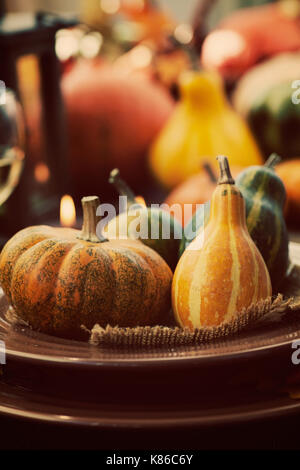 Herbstliche Tischdekoration mit Kürbissen. Gedeck mit herbstlichen Dekoration. Stockfoto