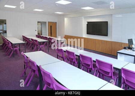 Eine moderne Klassenzimmer in einem neuen London secondary school. Zeigt traditionelles Layout mit Schreibtischen mit Blick auf einen großen Computer. Stockfoto