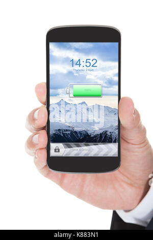 Hand Hält das Mobiltelefon mit geladenem Akku auf weißem Hintergrund Stockfoto
