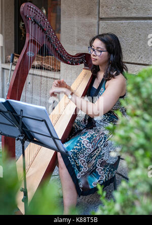 Harfenspieler spielt eine Harfe in der Altstadt von San Marino. Stockfoto