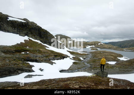 Typisch norwegische Landschaft mit schneebedeckten Bergen und Clear Lake in der Nähe der berühmten Aurlandsvegen (Bjorgavegen), Mountain Road, Aurland, Norwegen. Stockfoto