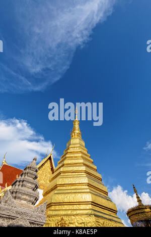 Wat Phra That Cho Hae Buddhismus Tempel mit goldenen Pagode auf blauen Himmel Hintergrund. Orte der Anbetung der Buddhisten und Sehenswürdigkeiten berühmt ist die Religion zu Phrae Stockfoto