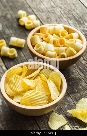 Knusprige Kartoffelchips und Ringe in der Schüssel. Gesalzene Kartoffelchips. Stockfoto
