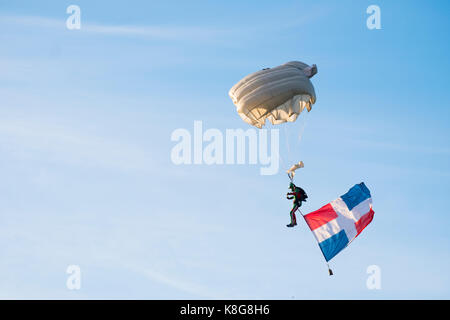 Low Angle View von Gleitschirm Paragliding mit Flagge gegen Sky Stockfoto