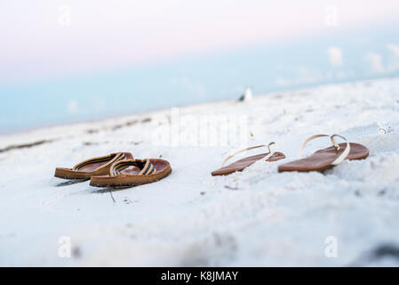 Paare Fuß Flops am Strand bei Sonnenaufgang Stockfoto