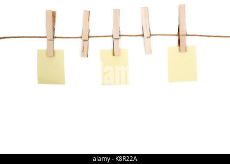 Leeres memo Papiere auf Seil mit Wäscheklammern, auf weißem Hintergrund. Stockfoto