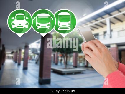 Digital composite Transport Icons und Hand Phone in Station Stockfoto