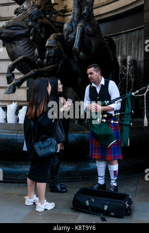 Touristinnen im Chat mit einem Street Entertainer, Piccadilly Circus, London, UK Stockfoto