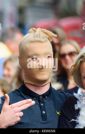 Mann mit Strumpf über Kopf und Hand wie eine Pistole auf der Royal Mile während des Edinburgh International Fringe Festival, Schottland, UK gebildet Stockfoto