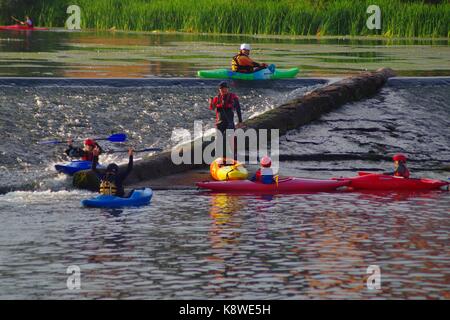 Kajakfahrer verhandeln Trews Wehr auf dem River Exe. Exeter, Devon, Großbritannien. August, 2017. Stockfoto