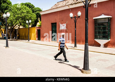 Fußgänger zu Fuß auf der Straße im historischen Zentrum. Coro, Bundesstaat Falcon, Venezuela. Stockfoto