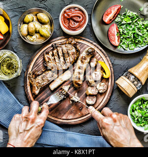 Der Mensch isst ein saftiges Steak grillen. film Effekt Stockfoto