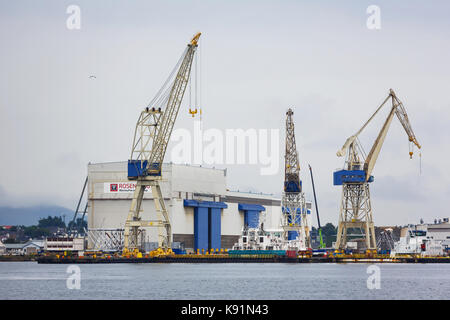 Stavanger, Norwegen - 24 August 2017: Krane in einem industriellen hafen von Stavanger im regnerischen Wetter Stockfoto