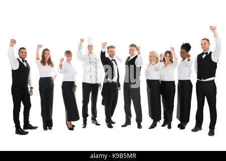 Volle Länge Portrait von glücklichen Angestellten im Restaurant feiert Erfolg gegen weißen Hintergrund Stockfoto