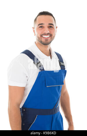 Portrait von glücklichen jungen Hausmeister vor weißem Hintergrund Stockfoto