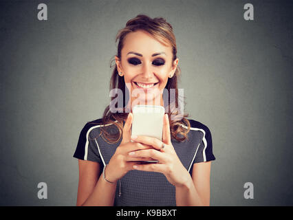 Junge lächelnde Frau mit einem Mobiltelefon Stockfoto