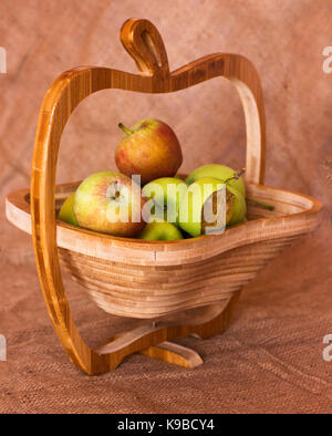 Grüne und rote Äpfel in der Holz- Vase Stockfoto
