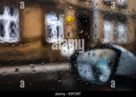 Regen Tag hinter dem Auto Fensterscheibe Glas, Foto vom Innenraum. Regen fällt auf den Bereich . Stockfoto