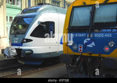 Eine ungarische Stadler FLIRT elektrische Lokomotive hinter einem H-Lokomotive, Westbahnhof, Budapest, Ungarn Stockfoto