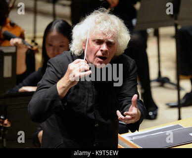 Sir Simon Rattle dirigiert am Abschlusstag von ÔThis is Rattle' 18-11-jährige Musiker aus dem Osten Londons im Barbican in London. DRÜCKEN SIE ZUORDNUNG. Bilddatum: Sonntag, 24. September 2017. Die 54 Jugendlichen treten mit LSO-Spielern und Musikern der Guildhall School auf, die alle Seite an Seite auf der Barbican Stage spielen und Musik aus Elgars ÔEnigma Variationen' und Strawinskys ÔThe Rite of Spring' aufführen. Die Aufführung ist Teil des ÔLSO On Track'-Programms, bei dem LSO-Spieler seit 2008 mit tausenden jungen Menschen aus dem Osten Londons in Aktivitäten arbeiten Stockfoto