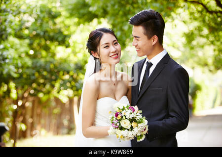 Outdoor Portrait von asiatische Braut und Bräutigam, glücklich und lächelnd. Stockfoto