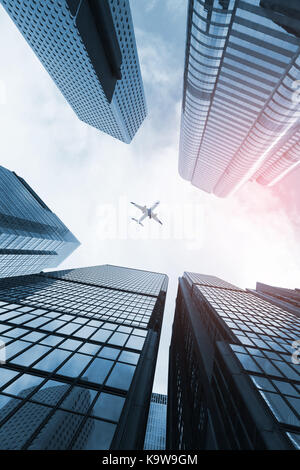 Moderne Skyline mit Passagierflugzeug fliegen über Business Wolkenkratzer, hohes Bürogebäude von Hong Kong City Stockfoto