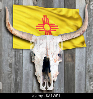 New Mexico Flagge und alte Kuh Schädel auf Holz- Hintergrund. Stockfoto