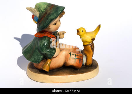 Goebel Hummel Produkte. Hummel Figurine Junge sitzt mit Gelben Vogel Stockfoto