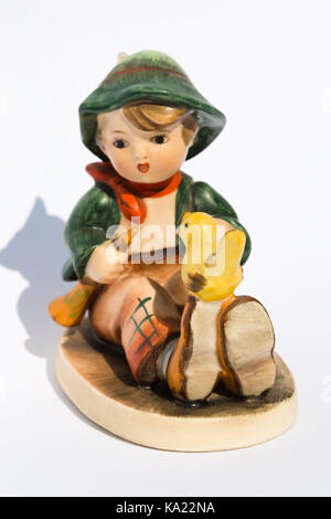 Goebel Hummel Produkte. Hummel Figurine Junge sitzt mit Gelben Vogel Stockfoto