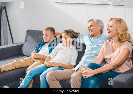 Glückliche Familie sitzt auf einem Sofa Stockfoto