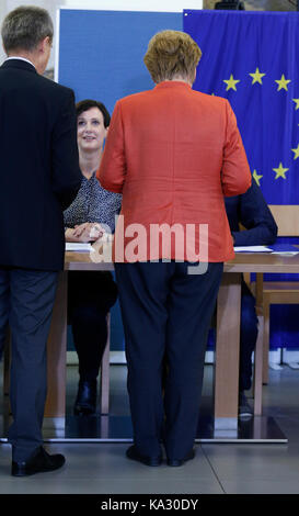 Berlin, Deutschland. 24. September, 2017. Bundeskanzlerin Angela Merkel setzt eine Abstimmung im allgemeinen Wahl zum Deutschen Bundestag am 24. September 2014. Sie sorgte mit ihrem Ehemann. Angela Merkel hofft, die Wahl zu gewinnen und für eine weitere Amtszeit als Kanzler der das mächtigste Land in der Europäischen Union dienen. Credit: Dominika Zarzycka/Alamy leben Nachrichten Stockfoto