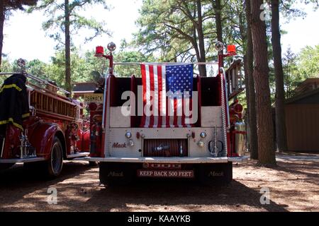 Eine amerikanische Flagge ist stolz auf der Rückseite einer vintage Mack Fire Engine angezeigt. Stockfoto