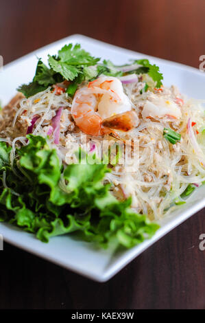 Yum Woonsen Glas Nudelsalat, Glasnudeln Salat auf einem Bett von Salat mit Huhn und Garnelen serviert. Stockfoto