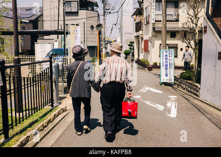 Jeden Tag Street Scene in Japan. Reifes Paar gehen Hand in Hand Stockfoto