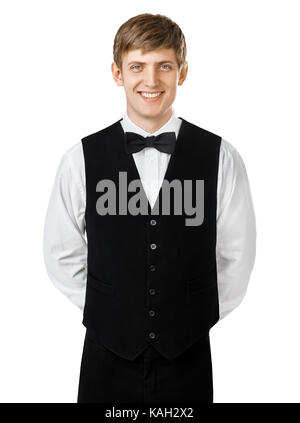 Portrait der junge lächelnde Kellner stehen mit den Händen hinter seinem Rücken isoliert auf weißem Hintergrund Stockfoto