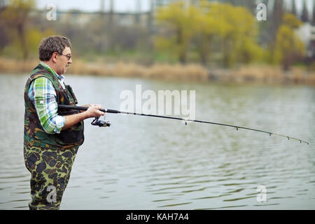 Reifen angler angeln am Fluss Stockfoto