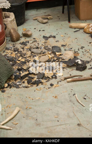 Feuerstein-Knapping-Demonstration, indem man lernt, mit Knochenwerkzeugen von Hand eine Pfeilspitze aus Feuerstein zu machen Stockfoto