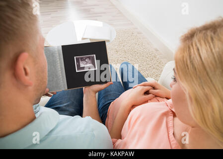 Hohe Betrachtungswinkel von jungen erwartet Ehepaar am Ultraschall suchen Foto scannen Stockfoto