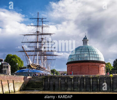 London, Greenwich, Cutty Sark, historische Clipper, alten Segelschiff und Masten neben dem grünen gewölbten Eingang zum Tunnel unter der Themse Stockfoto