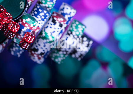 Casino Konzept. Roulette, Chips, Karten und Würfel auf bunten Bokeh. Stockfoto