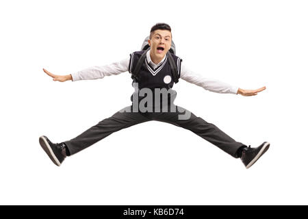 Überglücklich teenage Student in einem einheitlichen auf weißem Hintergrund springen Stockfoto