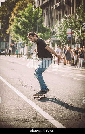 Pro Skate rider ride Skateboard vor dem Auto auf die Stadt Straße Straße durch Staus Stockfoto