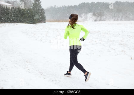 Frau läuft im Winter Stockfoto