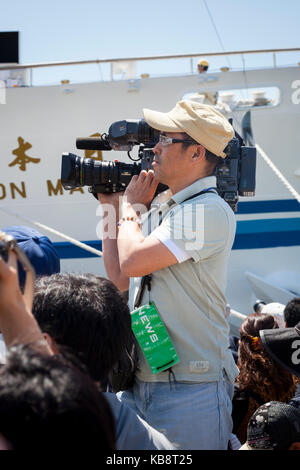 Nagasaki, Japan - 28. April 2012: news Kameramann mit einem tragbaren Fernseher Kamera auf der Schulter in Nagasaki Tall Ships Festival. Stockfoto