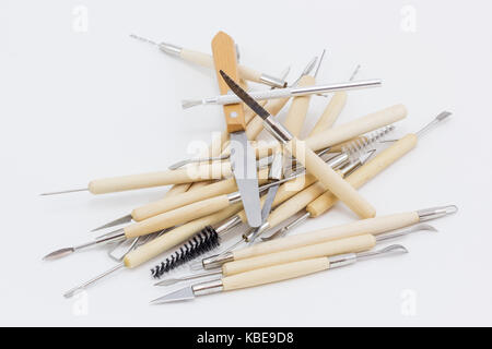 Ein Haufen von Skulptur tools, aus Holz und Metall, auf eine weiße Fläche. Stockfoto