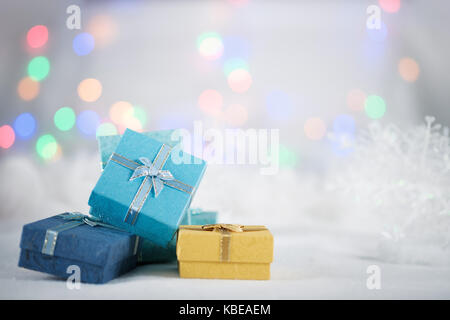 Bunte Geschenkboxen auf dem weißen Fell am bokeh Hintergrund, mit Kopie Raum für Saison Gruß. frohe Weihnachten und ein glückliches neues Jahr. AF-Messfeld Auswahl, bl Stockfoto